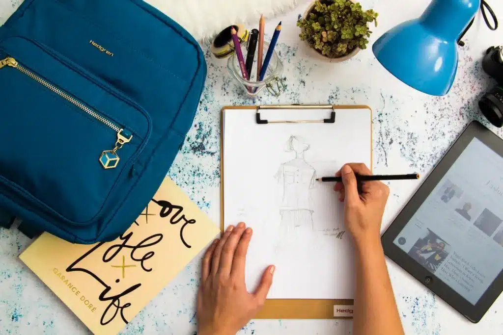 Person Sketching Dress on Printer Paper With Clip Board. These mindfulness tricks help to reduce stress and cause stress relief.