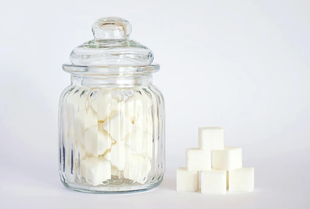 Close-Up Photo of Sugar Cubes in Glass Jar, unprocessed foods , healthier diet, balanced diet