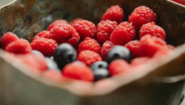 Appetizing ripe raspberries and blueberries in bowl. mindful consumption, nutritional well-being, Balanced diet, improve mindfulness